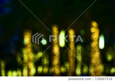 Abstract bokeh effect of the gold, yellow lights on black background. City street light decorations. Rows of LED gold colored light spots with black background. Abstract bokeh effect of the gold, yellow lights on black background. City street light decorations. Rows of LED gold colored light spots with black background. 138007418