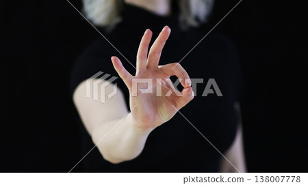a hand symbol with a finger folded, meaning OK a hand symbol with a finger folded, meaning OK 138007778