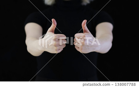 A human shows a thumbs up. Which means good. 138007788