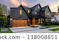 Striking Modern Farmhouse Exterior with Dark Siding and Warm Sunset Hues 138008851