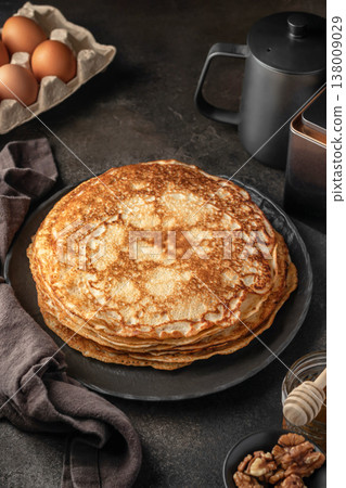 Stack of delicious crepes on dark brown table background Stack of delicious crepes on dark brown table background 138009029