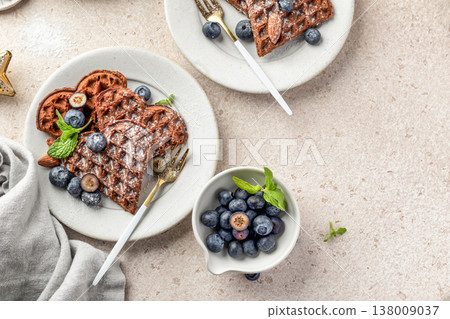 Heart shaped belgian waffles with blueberries and sugar powder. Valentines Day. Waffle day, top view 138009037