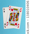 Playing cards on a blue background showing a king of hearts and an ace of spades in a casual setting for fun activities 138010406