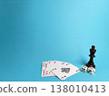 Playing cards and dice on a blue surface along with a chess piece showing a game setup 138010413
