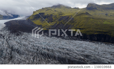 Aerial View of Glacier with Crevasses and Moss Covered Cliffs in Iceland Aerial View of Glacier with Crevasses and Moss Covered Cliffs in Iceland 138010668