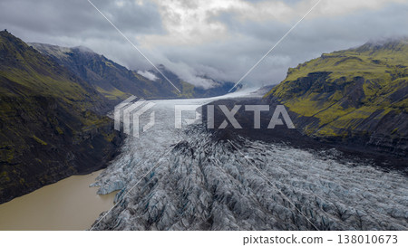 Aerial View of Icelandic Glacier with Crevasses and Volcanic Mountains Aerial View of Icelandic Glacier with Crevasses and Volcanic Mountains 138010673