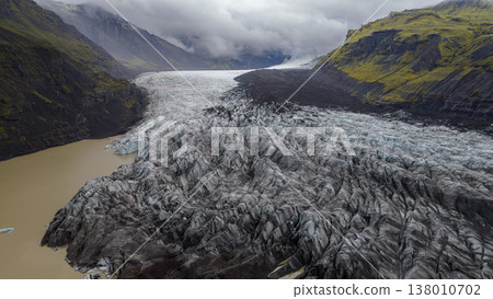 Aerial View of Icelandic Glacier with Crevasses and Glacial Lake 138010702