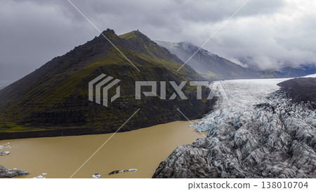 Aerial View of Icelandic Glacier and Glacial Lake with Rugged Mountain Aerial View of Icelandic Glacier and Glacial Lake with Rugged Mountain 138010704