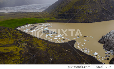 Aerial View of Glacial Lagoon with Ice Chunks and Volcanic Terrain Aerial View of Glacial Lagoon with Ice Chunks and Volcanic Terrain 138010706