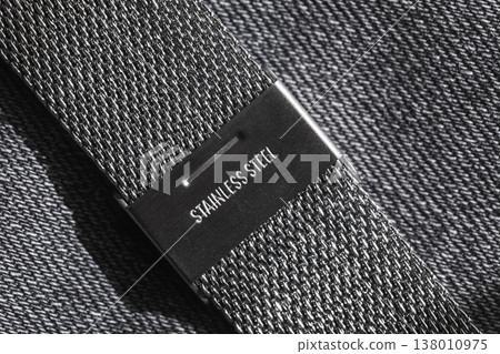 Close-up macro of a stainless steel mesh watch strap and clasp 138010975