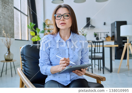 Webcam view woman entrepreneur, teacher working online remotely in home office Webcam view woman entrepreneur, teacher working online remotely in home office 138010995