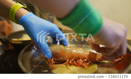 Preparing prawn tail in pan with vibrant kitchen elements 138011170