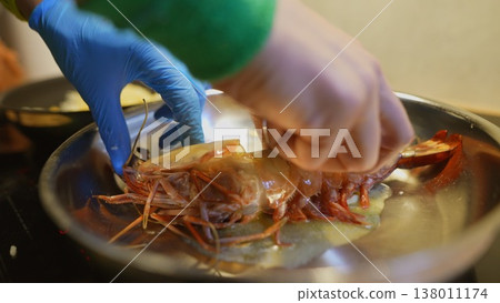Highly trained chef expertly searing prawns with finesse in kitchen Highly trained chef expertly searing prawns with finesse in kitchen 138011174