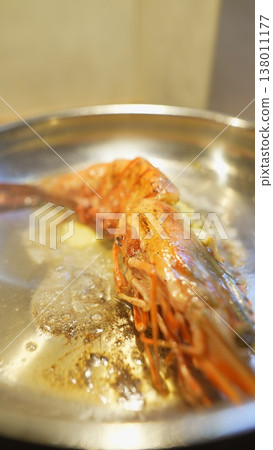 Prawn oil bubbling. Closeup of prawn shell with heat and bubbling oil Prawn oil bubbling. Closeup of prawn shell with heat and bubbling oil 138011177