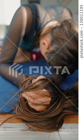 Gentle repose with soft sunlight illuminating relaxed long hair 138011195