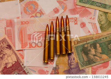 Military cartridges on yuan symbolize conflict costs and financial pressure 138011245