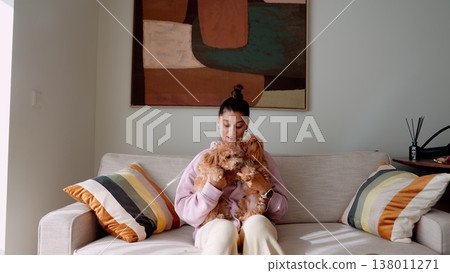 Calm woman with pet at home. Evening tranquility with lady and dog 138011271