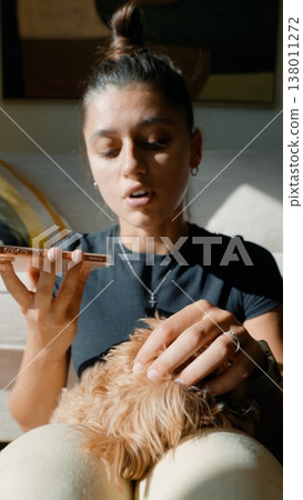 Closeup of woman capturing voice while embracing playful puppy Closeup of woman capturing voice while embracing playful puppy 138011272