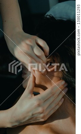 Focused therapist creating trust during ear mobilization Focused therapist creating trust during ear mobilization 138011293