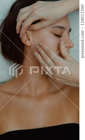 Relaxing facial therapy involves soothing gesture and skin renewal Relaxing facial therapy involves soothing gesture and skin renewal 138011380