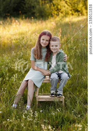 Family Gathering Capturing Joyful Moments Amidst Blooming Wildflowers And Golden Sunset 138011838