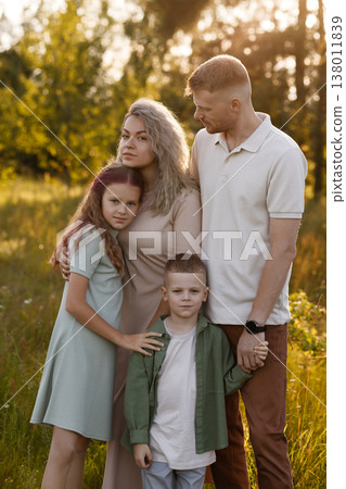 Sunlit Meadow Family Embrace. Joyful Family Members Sharing Affectionate Moments Outdoors Sunlit Meadow Family Embrace. Joyful Family Members Sharing Affectionate Moments Outdoors 138011839