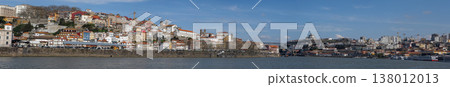 Panoramic view of Porto riverside cityscape with colorful houses and historic architecture by Douro river 138012013
