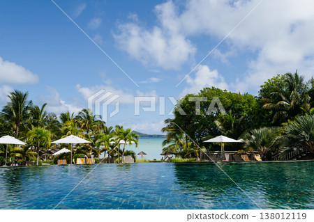 Infinity pool, sunbeds and umbrellas in Mauritius resort. Infinity pool, sunbeds and umbrellas in Mauritius resort. 138012119