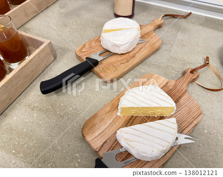 Soft cheese brie or camembert on wooden board with knife kitchen serving Soft cheese brie or camembert on wooden board with knife kitchen serving 138012121