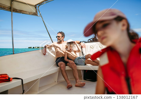 Family relaxing on boat during tropical family vacation. Family relaxing on boat during tropical family vacation. 138012167