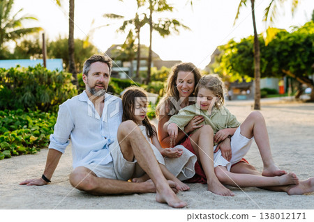 Family enjoying tropical beach vacation at luxury resort. Family enjoying tropical beach vacation at luxury resort. 138012171
