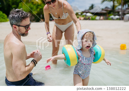 Family at tropical beach vacation at luxury resort. Family at tropical beach vacation at luxury resort. 138012222