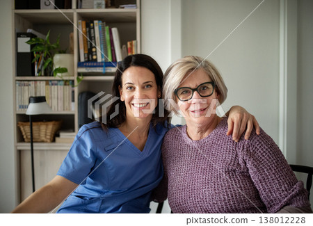 Portrait of physiotherapist and senior woman during rehabilitation exercise. 138012228