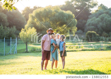 Family on walk in summer nature, standing under apple tree. Family on walk in summer nature, standing under apple tree. 138012353