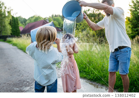 Traditional Easter Monday water ritual in rural countryside. 138012402