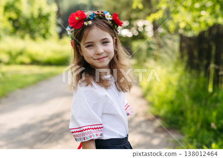 Young girl in folk costume celebrating Easter and spring traditions. Young girl in folk costume celebrating Easter and spring traditions. 138012464