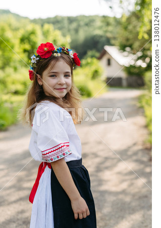Young girl in folk costume celebrating Easter and spring traditions. Young girl in folk costume celebrating Easter and spring traditions. 138012476