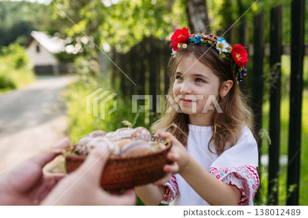 Young girl holding traditionally decorated Easter eggs with folk patterns Young girl holding traditionally decorated Easter eggs with folk patterns 138012489