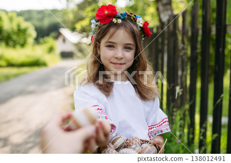 Young girl holding traditionally decorated Easter eggs with folk patterns Young girl holding traditionally decorated Easter eggs with folk patterns 138012491
