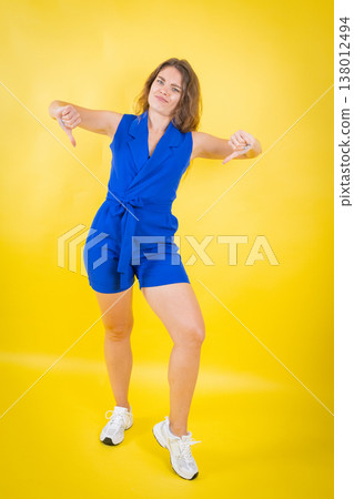 Woman expressing disapproval giving two thumbs down Woman expressing disapproval giving two thumbs down 138012494