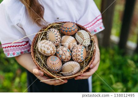 Young girl holding traditionally decorated Easter eggs with folk patterns Young girl holding traditionally decorated Easter eggs with folk patterns 138012495
