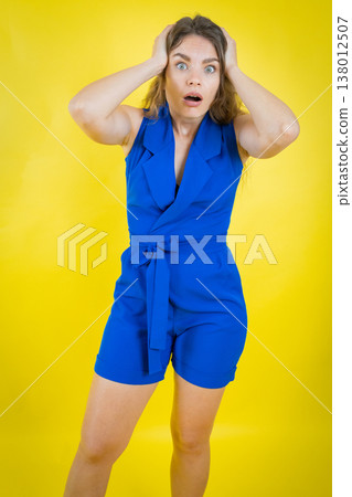 Woman expressing shock, hands on head, wide eyes 138012507
