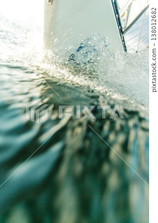 Yachting on sail boat bow stern shot splashing water Yachting on sail boat bow stern shot splashing water 138012682