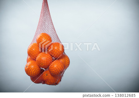 Fresh oranges fruits in mesh from supermarket Fresh oranges fruits in mesh from supermarket 138012685
