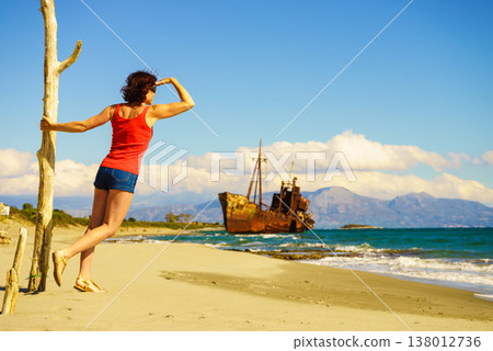 Tourist woman on beach enjoying vacation Tourist woman on beach enjoying vacation 138012736