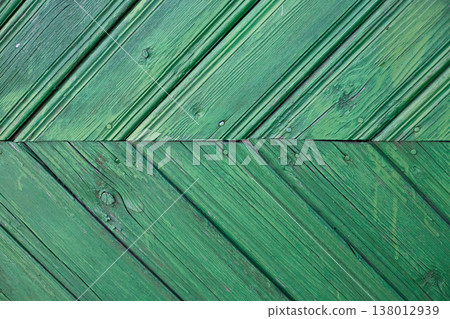 Green wooden lining with a chevron pattern and weathered texture. Detailed background with aged timber planks Green wooden lining with a chevron pattern and weathered texture. Detailed background with aged timber planks 138012939