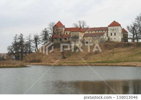 Svirzh Castle on a grassy hill overlooking a lake Svirzh Castle on a grassy hill overlooking a lake 138013046