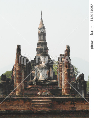 Ancient Buddha statue and ruins of Wat Mahathat in Sukhothai Historical Park Thailand Ancient Buddha statue and ruins of Wat Mahathat in Sukhothai Historical Park Thailand 138013062