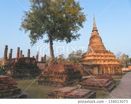 Ancient brick stupas and stone pathway at sunrise in Sukhothai Ancient brick stupas and stone pathway at sunrise in Sukhothai 138013073