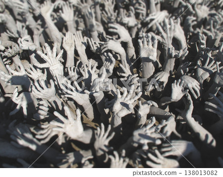 Sculptures of reaching hands from hell at Wat Rong Khun White Temple in Chiang Rai 138013082